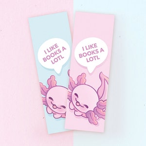 Könnte beinhalten: Zwei rosa und blaue Lesezeichen mit einem Cartoon-Axolotl und dem Text "Ich mag Bücher sehr" in einer Sprechblase.