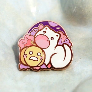 May include: White enamel pin featuring a cartoon cat holding a pumpkin with a spooky face. The cat is surrounded by purple and pink flowers and a crescent moon.