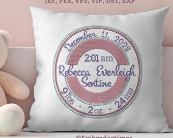 May include: A white pillow with a pink and green embroidered circle. The circle includes the text "December 11, 2023", "2:01 am", "Rebecca Everleigh Sentine", "9 lbs", "2 oz", and "24 ins".