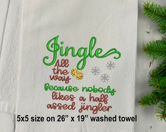 May include: White Christmas-themed towel with green and red embroidered text that reads "Jingle All the Way Because nobody likes a half assed jingler." The towel is 26 inches by 19 inches.