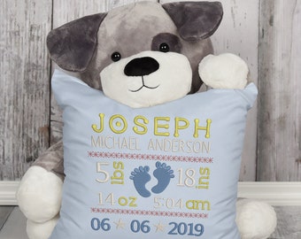 May include: A light blue pillow with embroidered text that reads "Joseph Michael Anderson", "5 lbs 18 in", "14 oz 5:04 am", and "06 06 2019". The pillow is decorated with a pair of blue embroidered footprints.