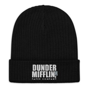 May include: Black knitted beanie with a white embroidered logo that reads "Dunder Mifflin, Inc. Paper Company"
