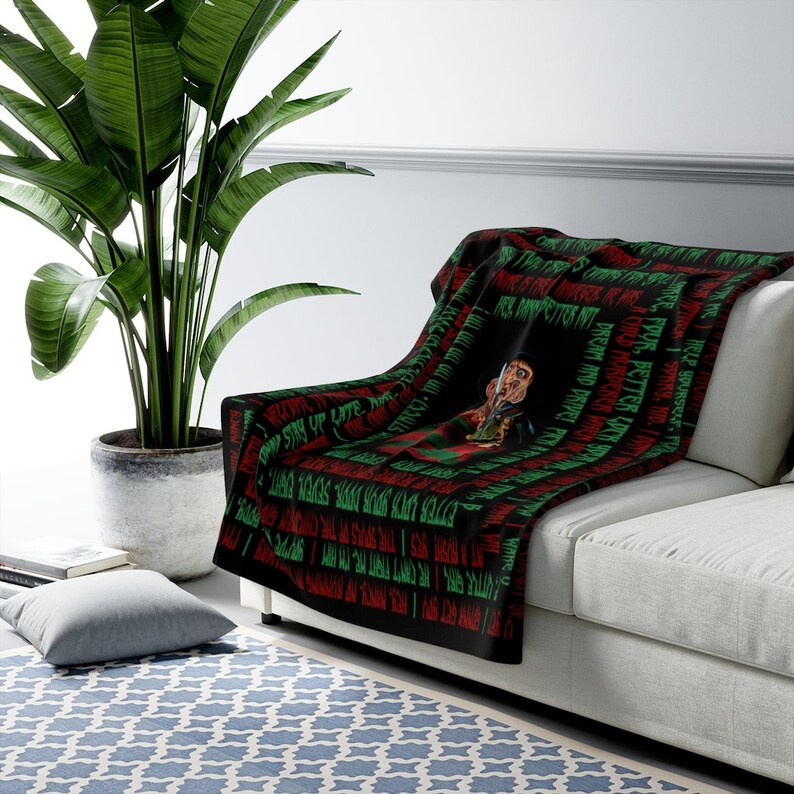 May include: Black and green fleece throw blanket with a repeating pattern of the words "I'm your worst nightmare" and a graphic of Freddy Krueger from the movie "A Nightmare on Elm Street".