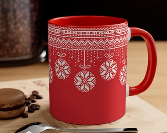 May include: Red ceramic mug with a white snowflake pattern and a white handle. The mug has a Christmas theme.