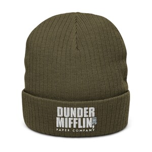 May include: A green knitted beanie with the embroidered text "Dunder Mifflin Inc. Paper Company" in white.