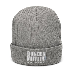 May include: Grey knitted beanie with the text "Dunder Mifflin Paper Company" embroidered in white.