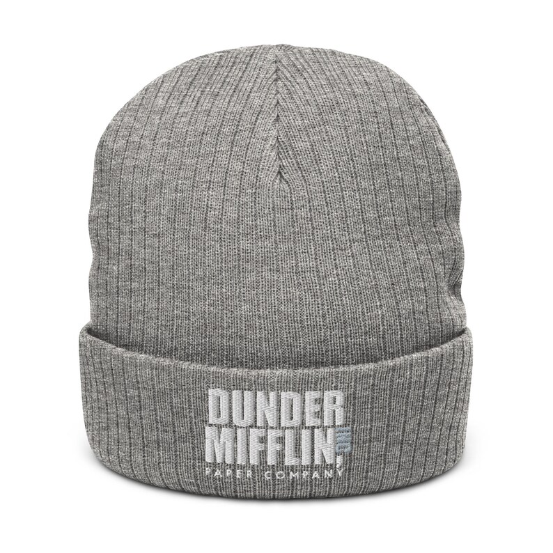 May include: Grey knitted beanie with the text "Dunder Mifflin Paper Company" embroidered in white.