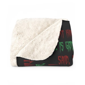 May include: Black fleece blanket with red and green text that reads "What have you got to say, I'm good."