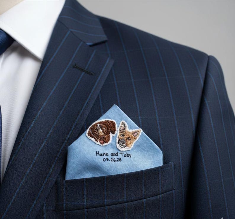 Navy pinstripe suit with a light blue pocket square embroidered with two dog portraits, their names and a wedding date.