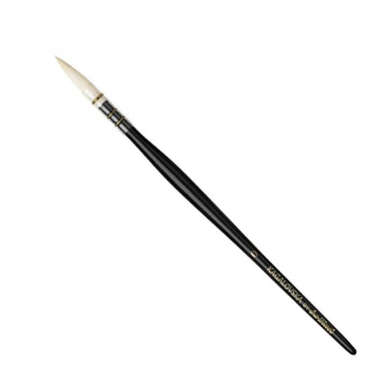 May include: A black-handled paintbrush with a pointed, light-colored brush head. The handle is sleek and glossy, with metallic accents near the brush head. The text "KAGALOVSKA by da Vinci" is printed on the handle.