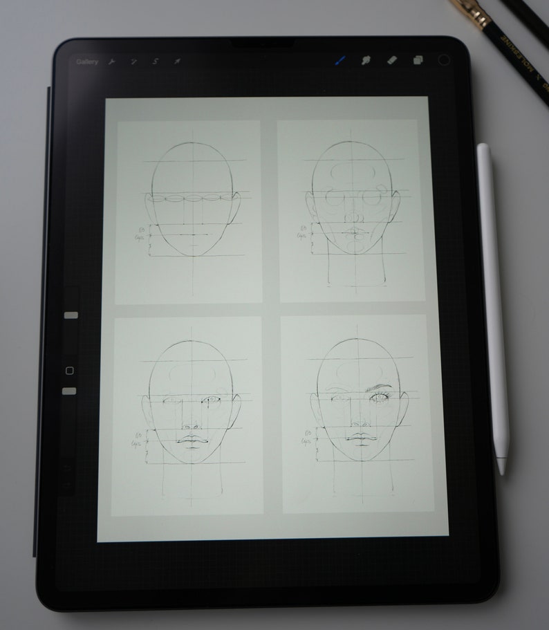 May include: A digital drawing tablet displaying four different stages of a face drawing tutorial. Each stage shows a face with a grid overlay, with the final stage showing a more detailed face with shading and features.