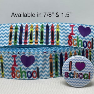 May include: Blue and white chevron ribbon with a row of colorful crayons and the text "I love school" with a purple heart. A matching 1.5 inch button with the same design is also included. Available in 7/8" and 1.5" sizes.