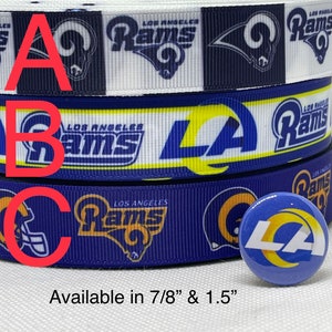 May include: Three rolls of blue, white, and yellow ribbon with the Los Angeles Rams logo. The ribbon is available in 7/8 inch and 1.5 inch widths. A small blue, yellow, and white button with the LA Rams logo is also shown.