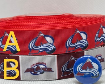 May include: Two rolls of red, white, and burgundy ribbon with the Colorado Avalanche logo printed on them. A blue button with the Avalanche logo is also included.