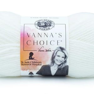 May include: A large, white ball of Vanna's Choice yarn. The label features the brand name, a photo of Vanna White, and the St. Jude Children's Research Hospital logo. The yarn is a soft, textured material.