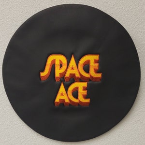 May include: Black leather patch with orange and yellow embroidered text that reads "SPACE ACE".