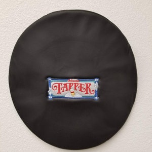 May include: Black leather beret with a blue, white, and red embroidered patch that says "Gellenkirchener Tapper" with a beer glass graphic.