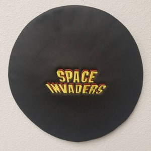 May include: Black beret with yellow and red embroidered text that reads "SPACE INVADERS".