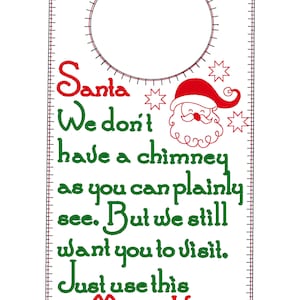 May include: A white door hanger with a red and green Santa Claus design. The text reads "Santa We don't have a chimney as you can plainly see. But we still want you to visit. Just use this Magic Key".