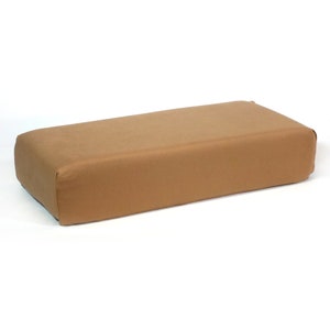 May include: A rectangular brown cushion with a soft, plush fabric cover.