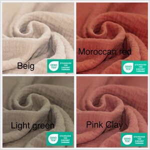 May include: Close-up of four fabric swatches in different colors: beige, Moroccan red, light green, and pink clay. Each swatch is labeled with its color name and features the Oeko-Tex Standard 100 label. The fabric appears to be a soft, textured material.