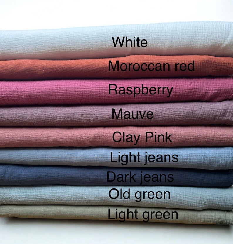 May include: A stack of fabric samples in various colors, including white, Moroccan red, raspberry, mauve, clay pink, light jeans, dark jeans, old green, and light green. Each fabric is labeled with its color name.