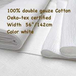 May include: White double gauze cotton fabric, Oeko-Tex certified. The fabric is 56 inches wide. The image shows a folded stack of the fabric and a portion of the fabric unfolded. The text on the image says "100% double gauze Cotton", "Oeko-tex certified", "Width 56"/142cm", and "Color white".