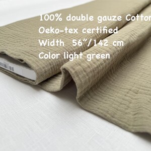 May include: Light green double gauze cotton fabric. The fabric is 56 inches wide and Oeko-tex certified. The text on the image reads: 100% double gauze Cotton, Oeko-tex certified, Width 56"/142 cm, Color light green.