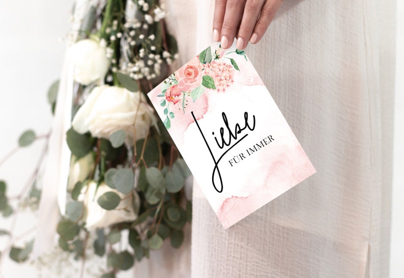 May include: A pink and white card with watercolor flowers and the text "Liebe f&uuml;r immer" in black script.