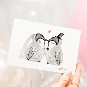 May include: A watercolor illustration of two owls wearing wedding attire. The owl on the left is wearing a veil and the owl on the right is wearing a top hat. The owls are kissing and there is a small red heart above them. The text "sweet love" is written below the owls.