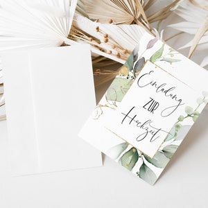 May include: A white card with gold accents and green watercolor leaves. The card says "Einladung zur Hochzeit" which translates to "Invitation to the Wedding" in English.