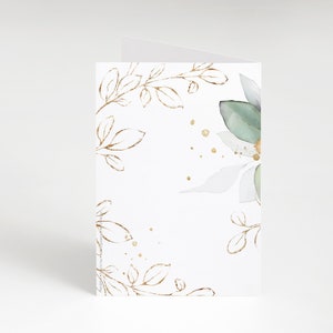 May include: A white card with a green and white watercolor floral design and gold leaf accents. The card has a blank space for writing a message.