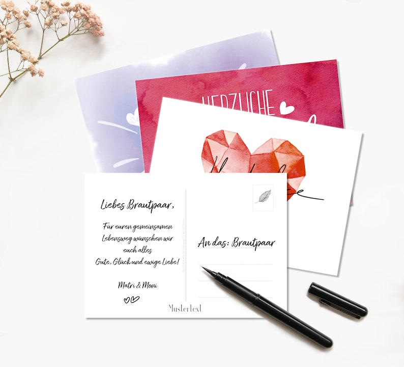 May include: A white postcard with a red watercolor heart and the text "Liebes Brautpaar, Far euren gemeinsamen Lebensweg w&uuml;nschen wir euch alles Gute, Gl&uuml;ck und ewige Liebe! Matri & Moni ♡♡ Mustertext An das: Brautpaar"