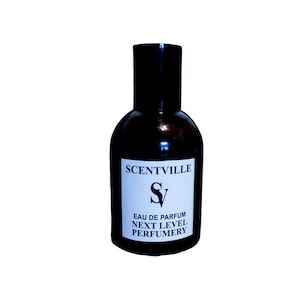 May include: A dark brown glass bottle with a black cap and a white label. The label says "SCENTVILLE" and "SV" in a stylized font. The label also says "EAU DE PARFUM NEXT LEVEL PERFUMERY".