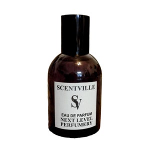 May include: A brown glass bottle of perfume with a black cap. The label reads "Scentville" with a stylized "SV" logo and the text "Eau de Parfum Next Level Perfumery".