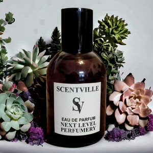 May include: A brown glass bottle of perfume with a black cap. The label reads "Scentville" and "Eau de Parfum Next Level Perfumery".