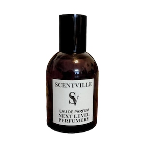 May include: A brown glass bottle of perfume with a black cap. The label reads "Scentville" with a stylized "SV" logo and the text "Eau de Parfum Next Level Perfumery".