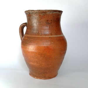Vintage terracotta clay  jug. Wabi sabi decor. Tall rustic vase.