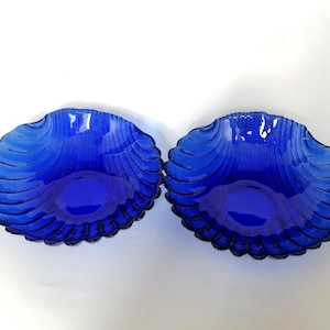 Set of 2 vintage blue glass bowls, with scalloped edges, perfect coastal gift for retro decor lovers.