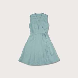 May include: A light blue linen wrap dress with a V-neck and a tie belt.