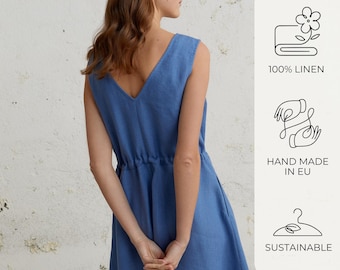 May include: A blue linen dress with a V-neckline and a drawstring waist. The dress is made of 100% linen and is hand-made in the EU. It is also sustainable.