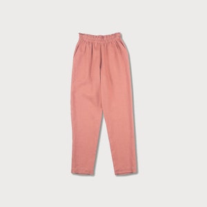 May include: A pair of loose-fitting, salmon-colored pants with an elastic waistband.