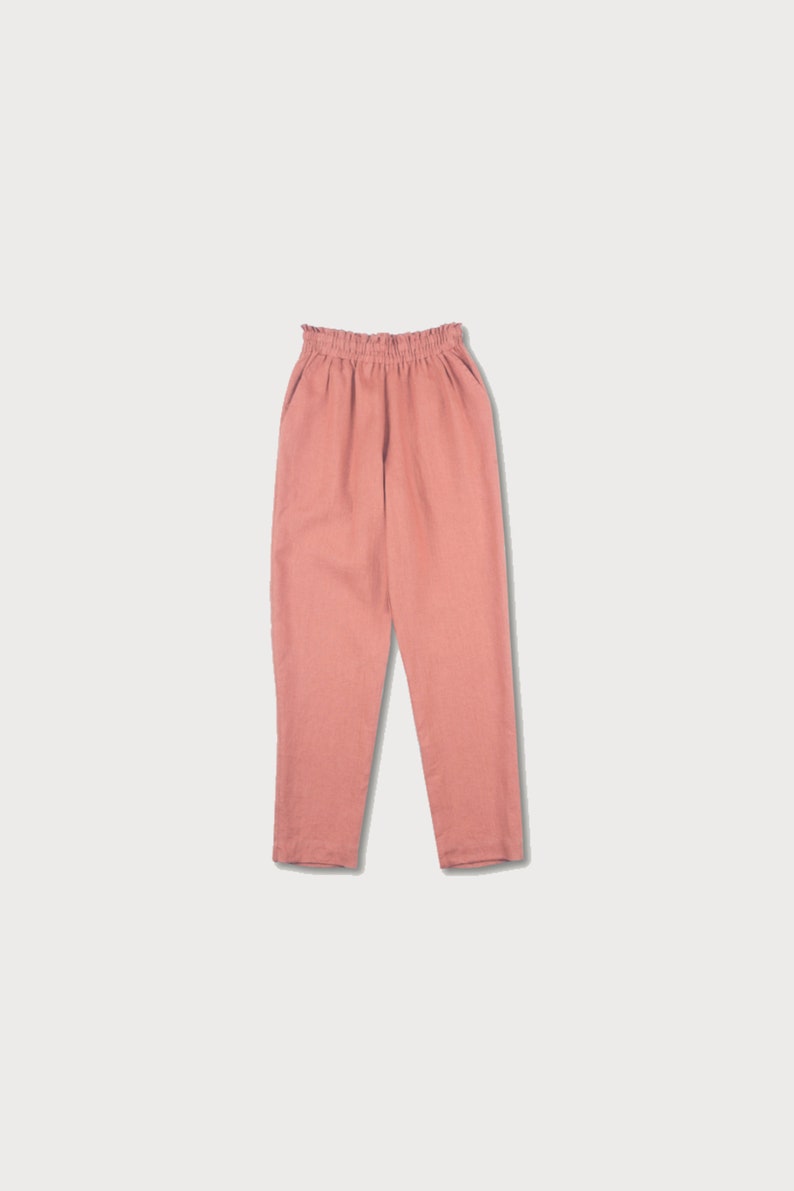 May include: A pair of loose-fitting, salmon-colored pants with an elastic waistband.