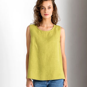 Chartreuse linen tank top with round neckline, front view on a model with blue jeans