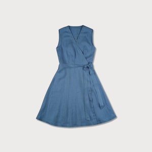 May include: A blue linen wrap dress with a V-neck and sleeveless design. The dress has a tie belt at the waist.