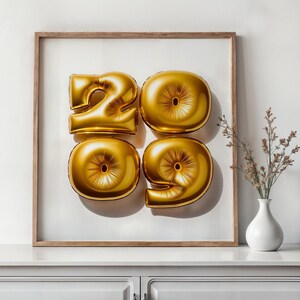 May include: Gold foil balloons shaped as the numbers 2009 are displayed within a wooden frame. The balloons are centered on a white background. A small white vase with dried flowers sits on a white cabinet below.