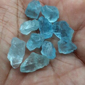 Puede incluir: Una colecci&oacute;n de diez peque&ntilde;os cristales de aguamarina azul claro. Los cristales son &aacute;speros y tienen un aspecto natural sin pulir.