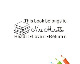 May include: Black and white illustration of a stack of books with the text "This book belongs to Mrs Marotta Read it Love it Return it"