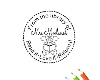 May include: Black and white illustration of a dragon reading a book. The text around the dragon reads "From the library of Mrs. McClensh Read it. Love it. Return it."