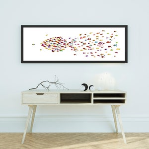 May include: A framed print of a colorful fish design. The fish are arranged in a school formation, creating the shape of a larger fish. The print is displayed on a white wall above a light wood console table.